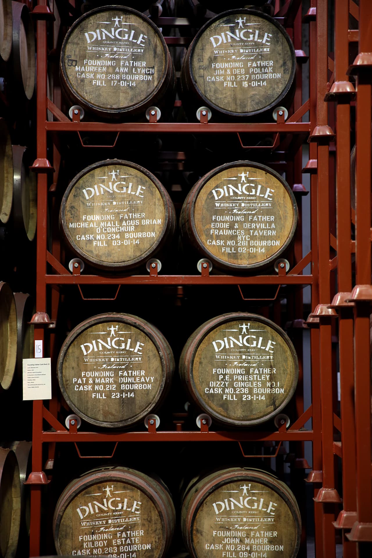 Founding Father casks of Dingle Whiskey Distillery racked in the maturation hall, each bourbon barrel stencilled with a founder's name and fill date