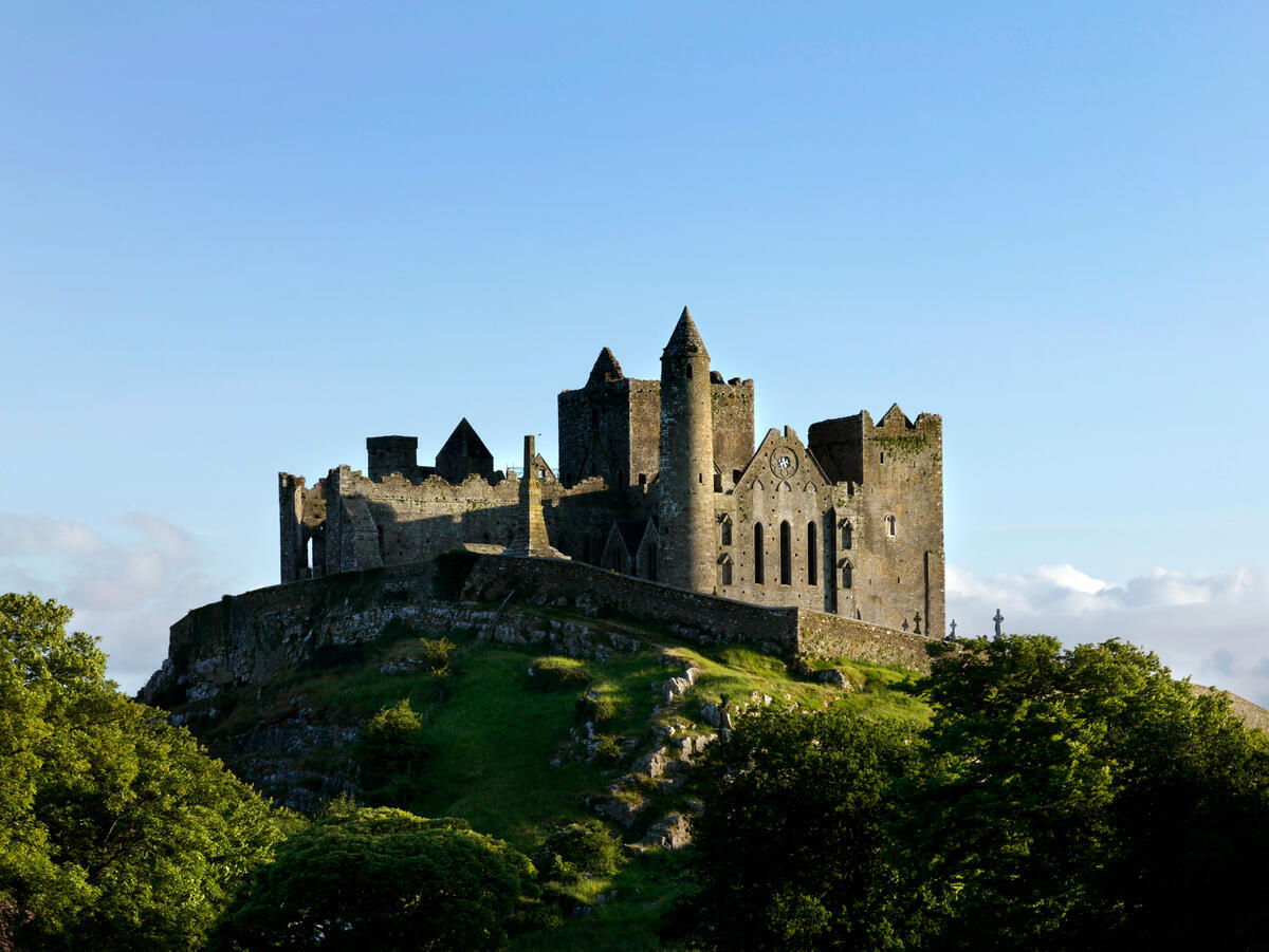 The Rock of Cashel rising above the plain of County Tipperary, with the round tower, Cormac's Chapel and the roofless cathedral visible on the summit