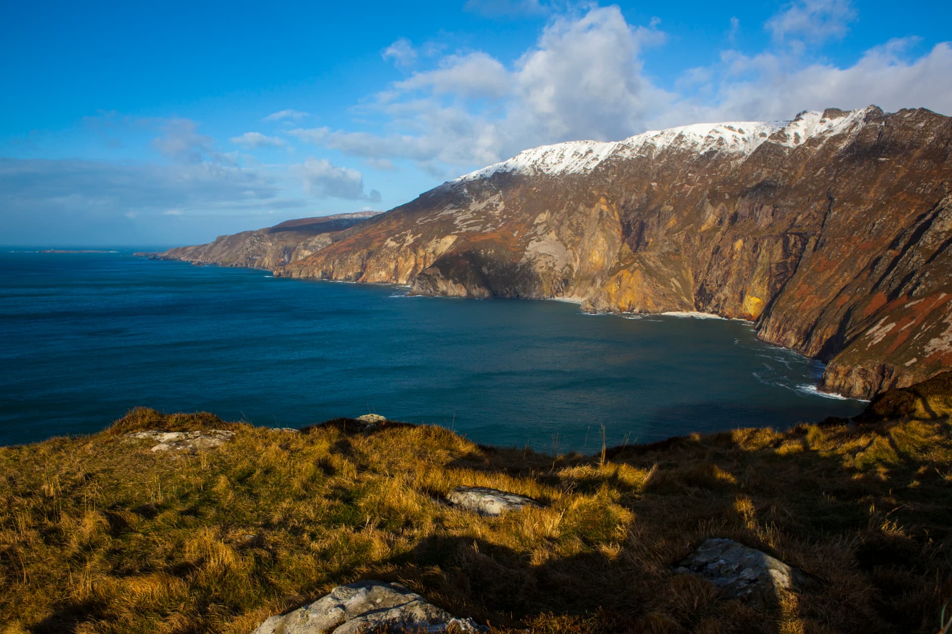 The Slieve League cliffs in County Donegal rising above the Atlantic, with snow on the summit ridge