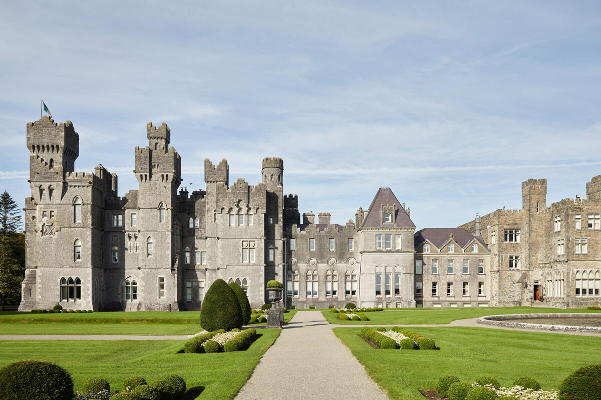 Ashford Castle and its reflection in the lake on a bright summer day